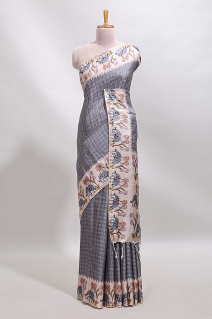 Grey checked tussar saree with contrast ikkat style elephant and floral print border and printed pallu