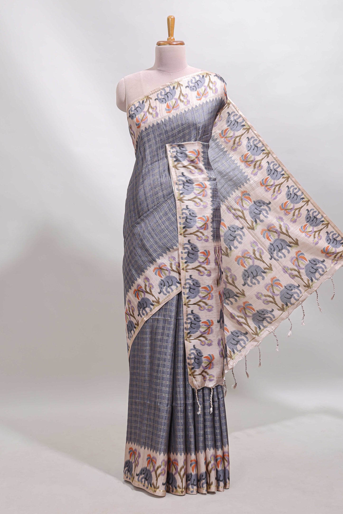 Grey checked tussar saree with contrast ikkat style elephant and floral print border and printed pallu
