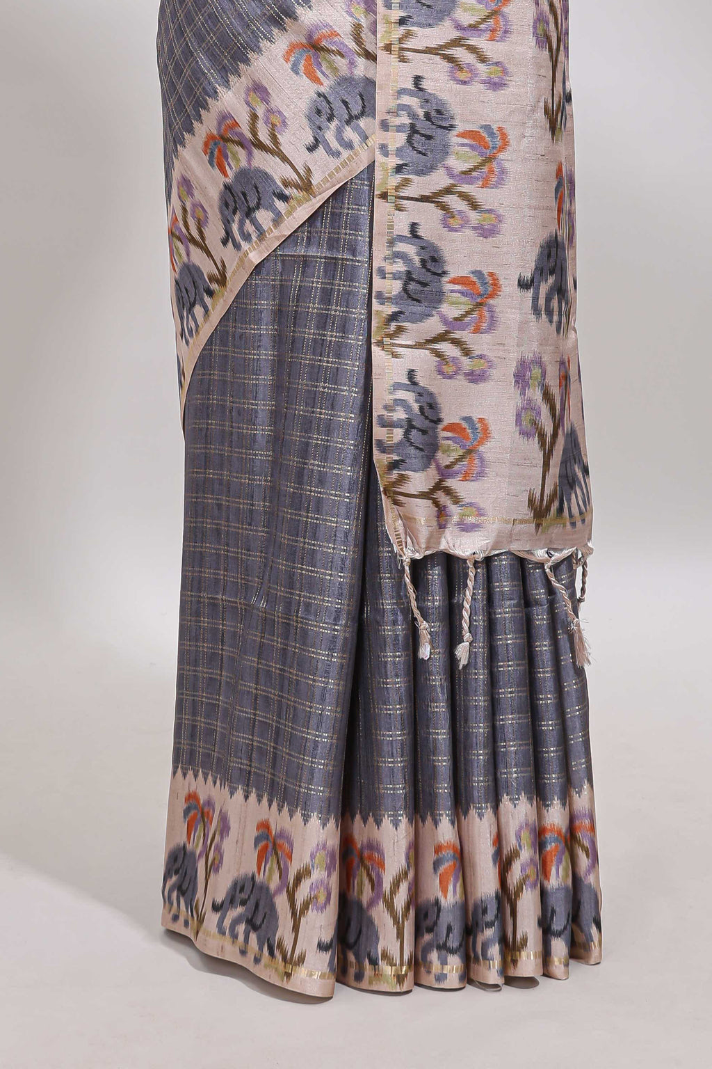 Grey checked tussar saree with contrast ikkat style elephant and floral print border and printed pallu