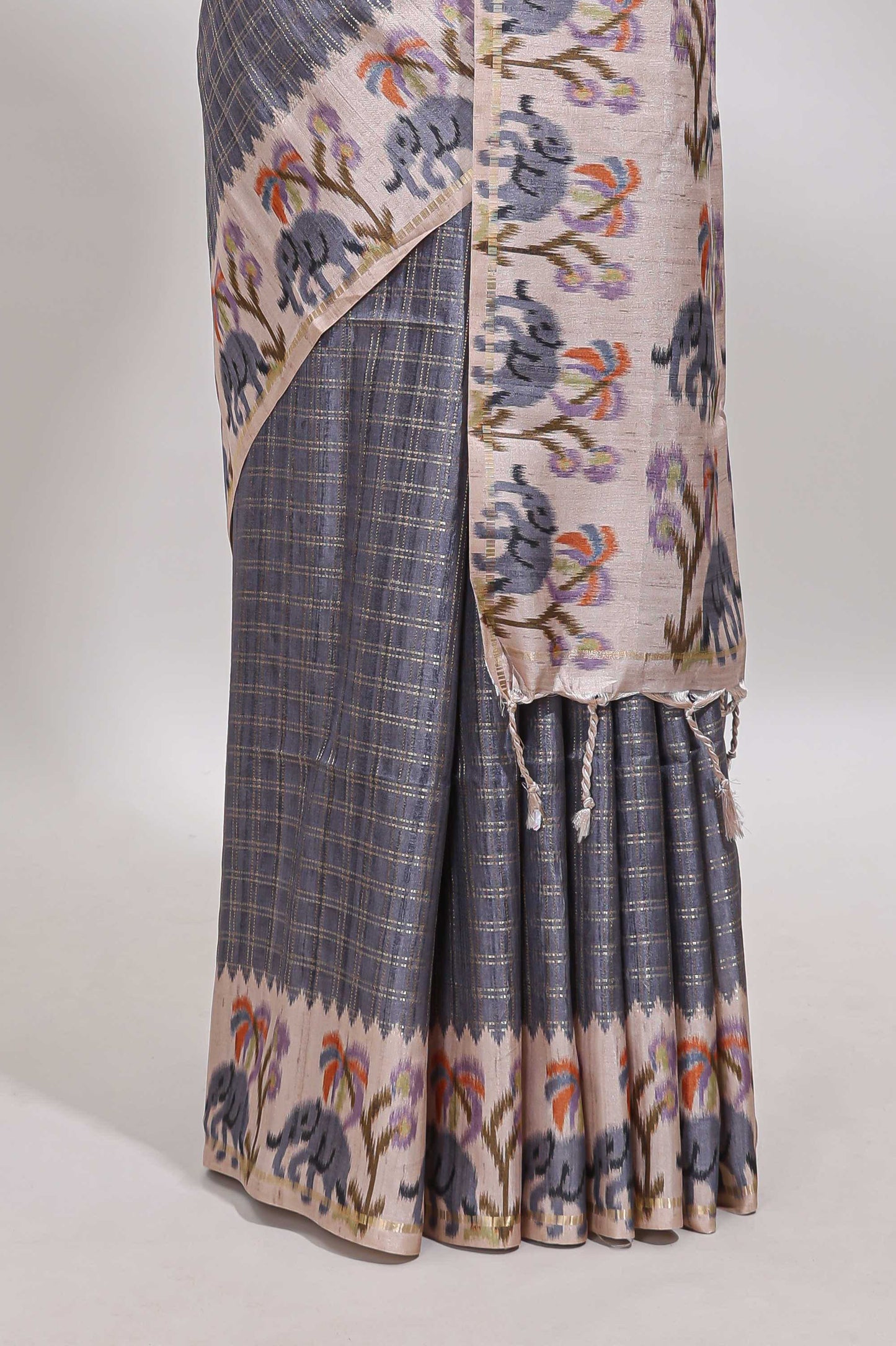 Grey checked tussar saree with contrast ikkat style elephant and floral print border and printed pallu