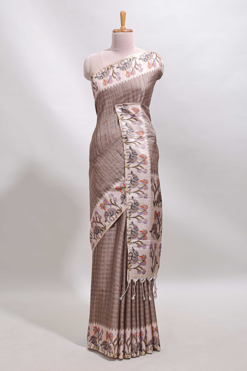 Beaver brown checked tussar saree with contrast ikkat style elephant and floral print border and printed pallu