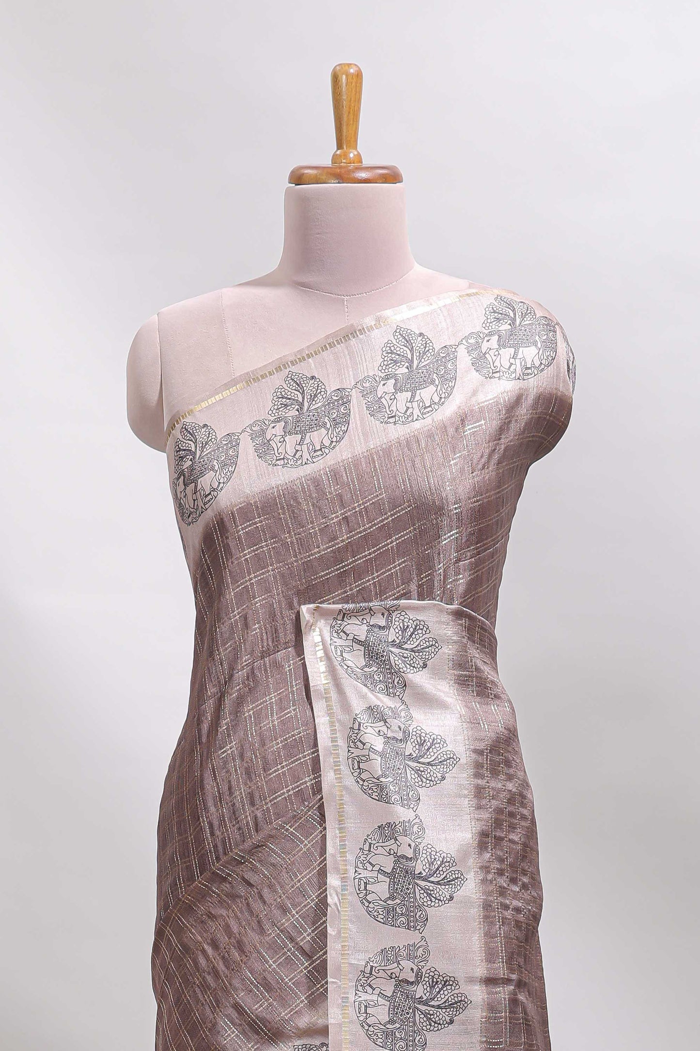 Brown checked tussar saree with contrast traditional elephant border and matching blouse