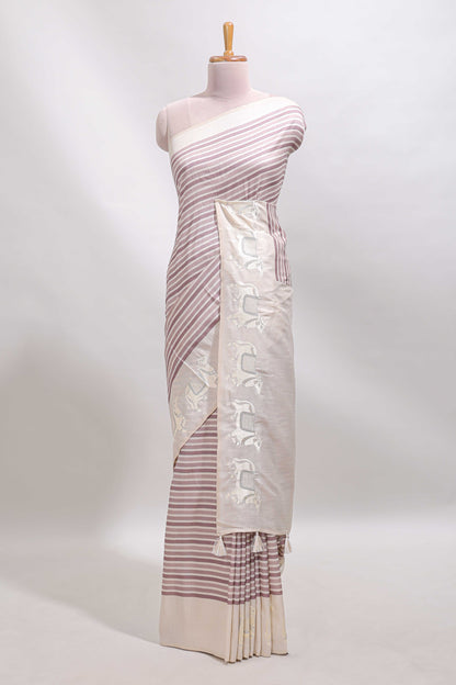 Cream striped tussar saree with contrast border and matching printed blouse