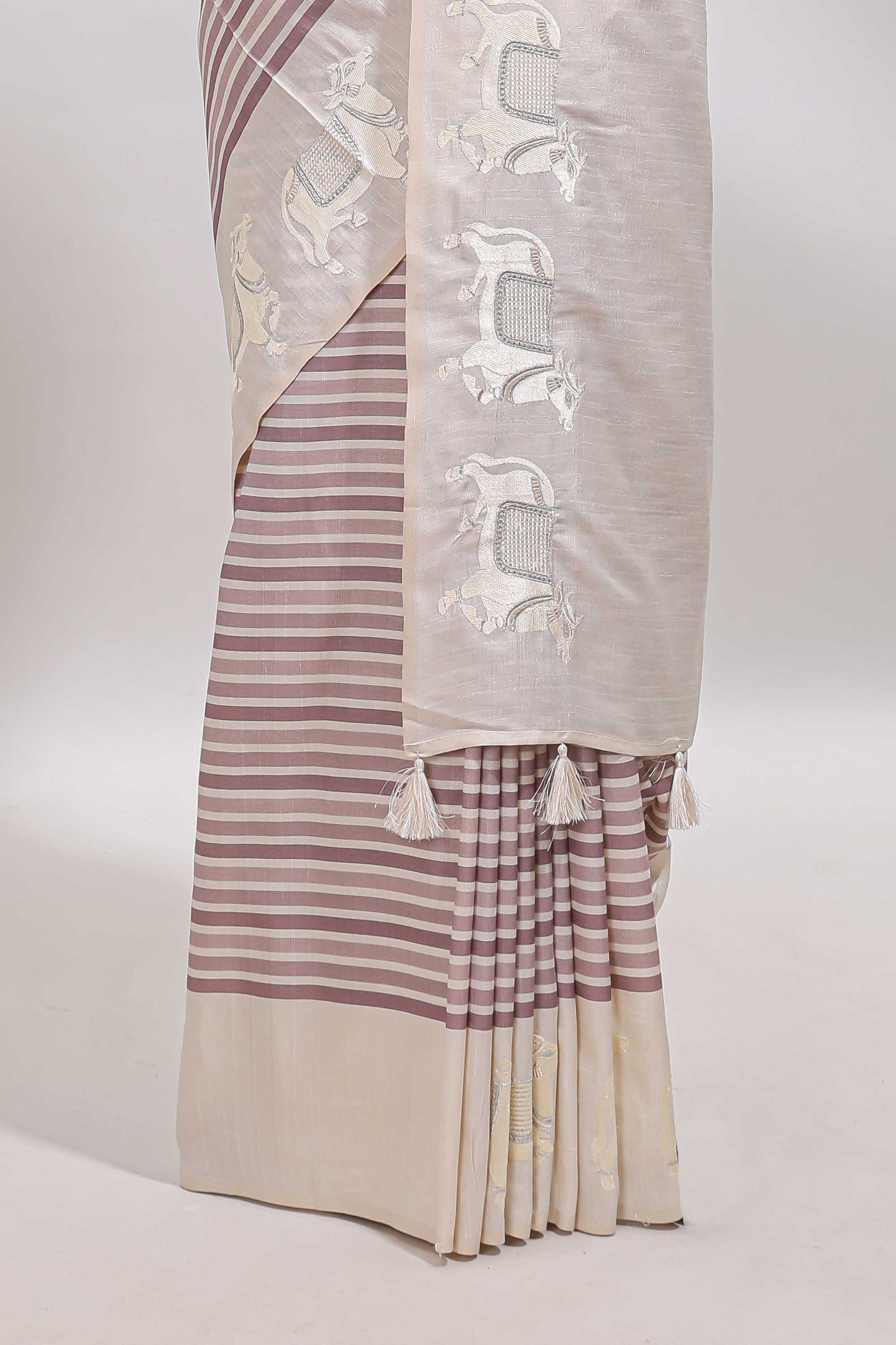 Cream striped tussar saree with contrast border and matching printed blouse
