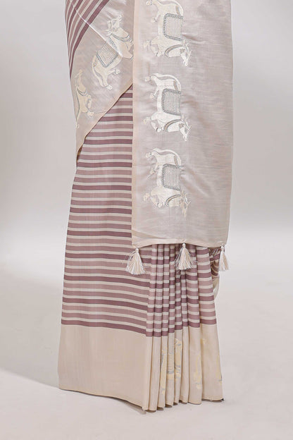 Cream striped tussar saree with contrast border and matching printed blouse