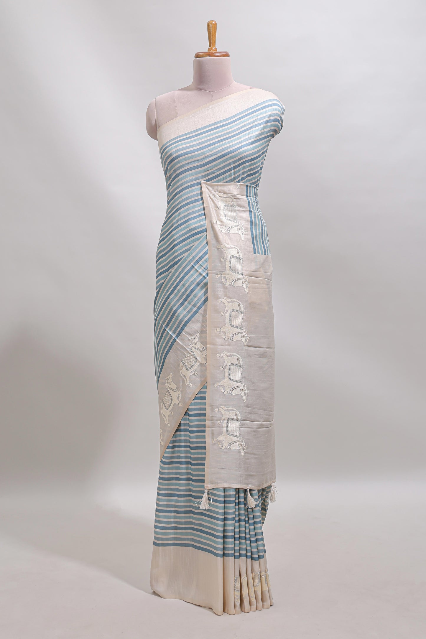 Cream striped tussar saree with contrast border and matching printed blouse
