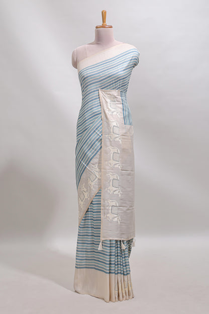 Cream striped tussar saree with contrast border and matching printed blouse