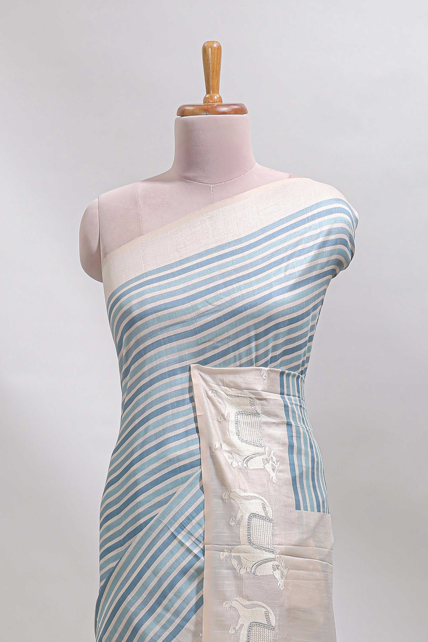 Cream striped tussar saree with contrast border and matching printed blouse