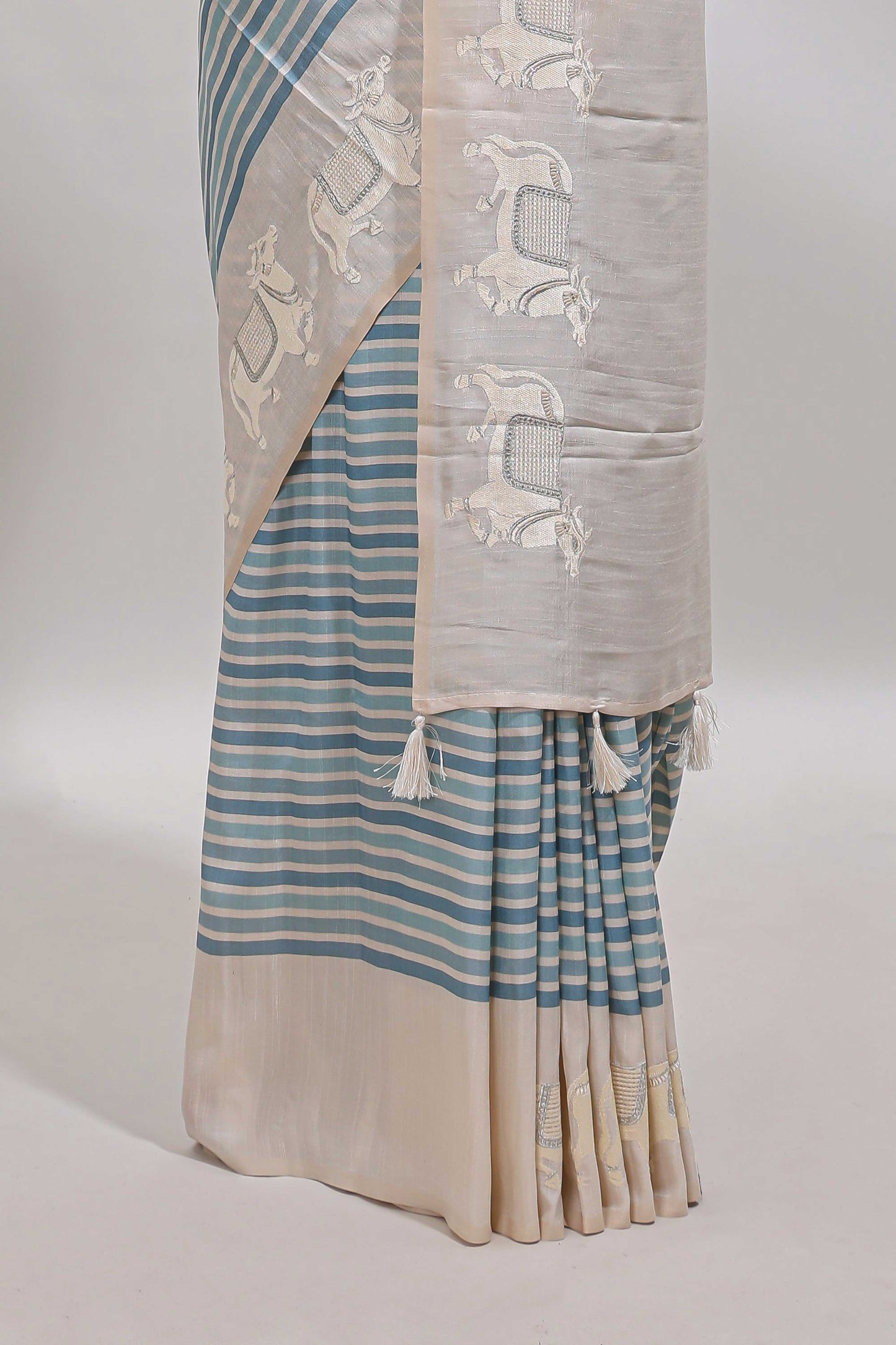 Cream striped tussar saree with contrast border and matching printed blouse