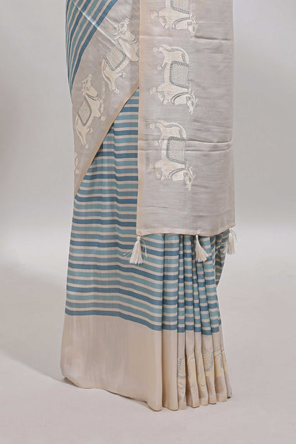 Cream striped tussar saree with contrast border and matching printed blouse