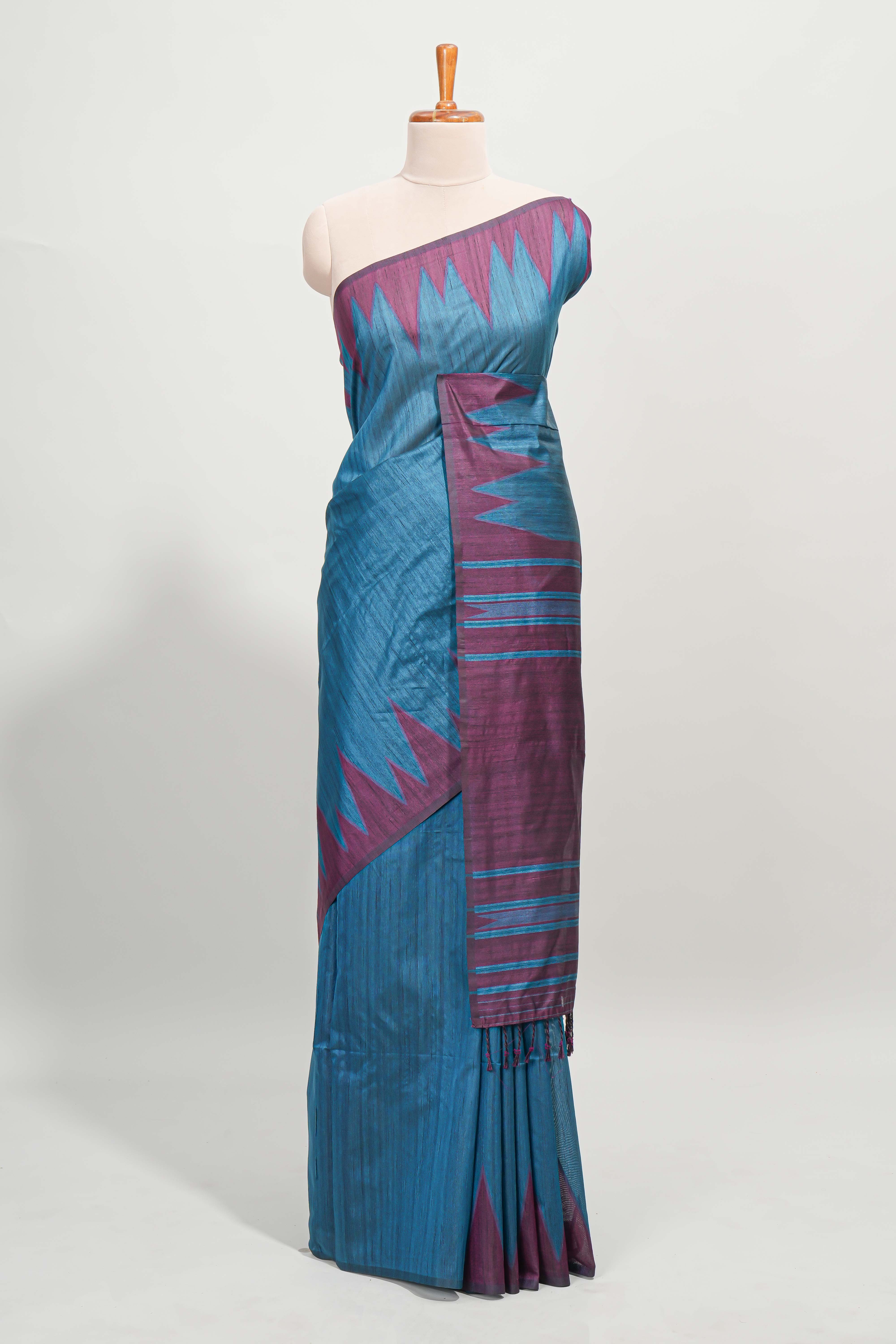 Blue plain semi tussar saree with contrast geometric border and motifs blouse