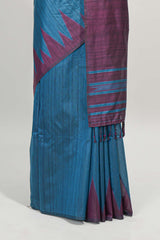 Blue plain semi tussar saree with contrast geometric border and motifs blouse