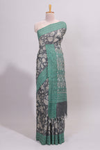 Grey floral design semi tussar saree with contrast green border and printed pallu
