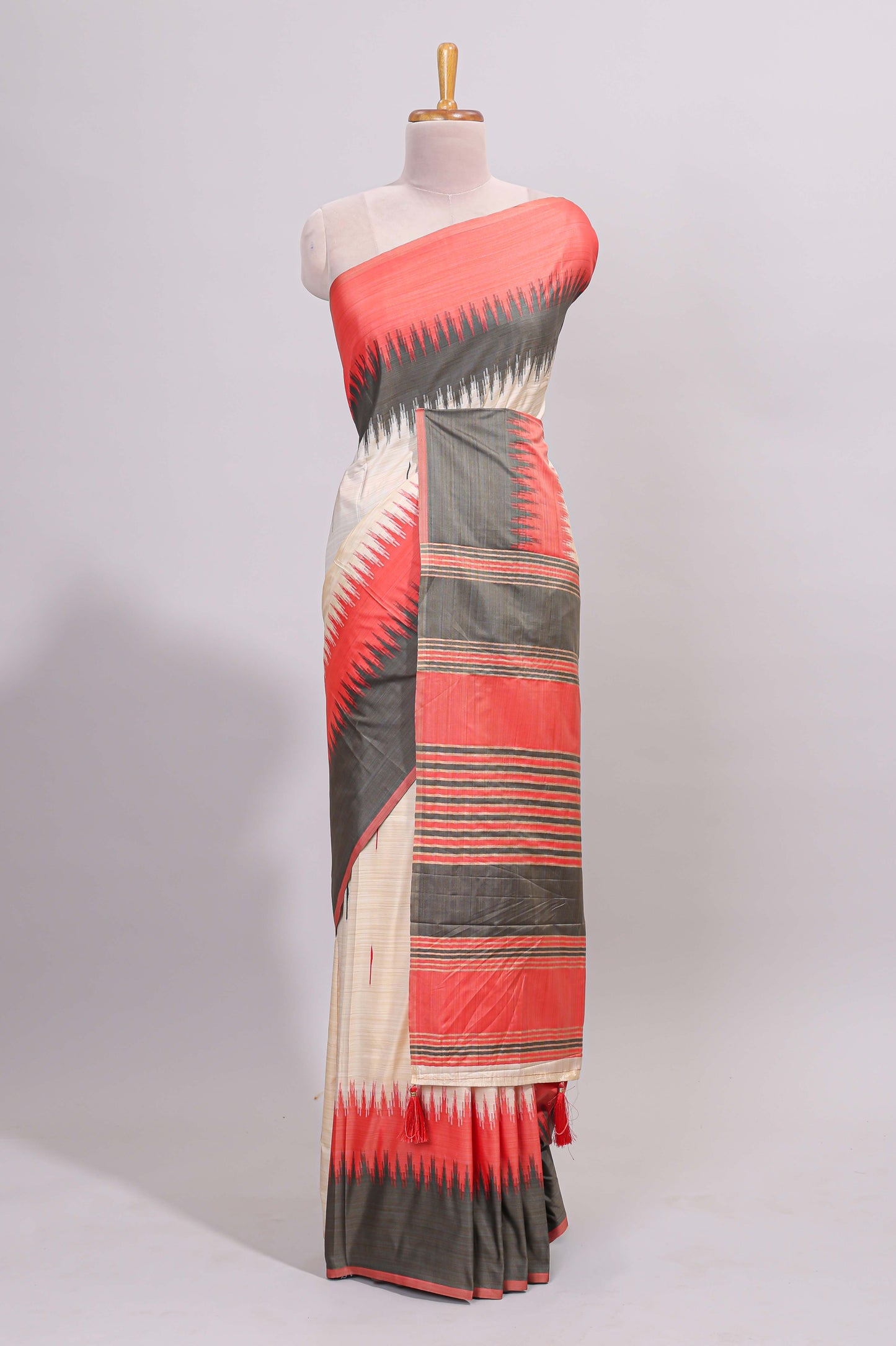 Off white ikkat design semi tussar saree with contrast dual shade border and matching striped blouse