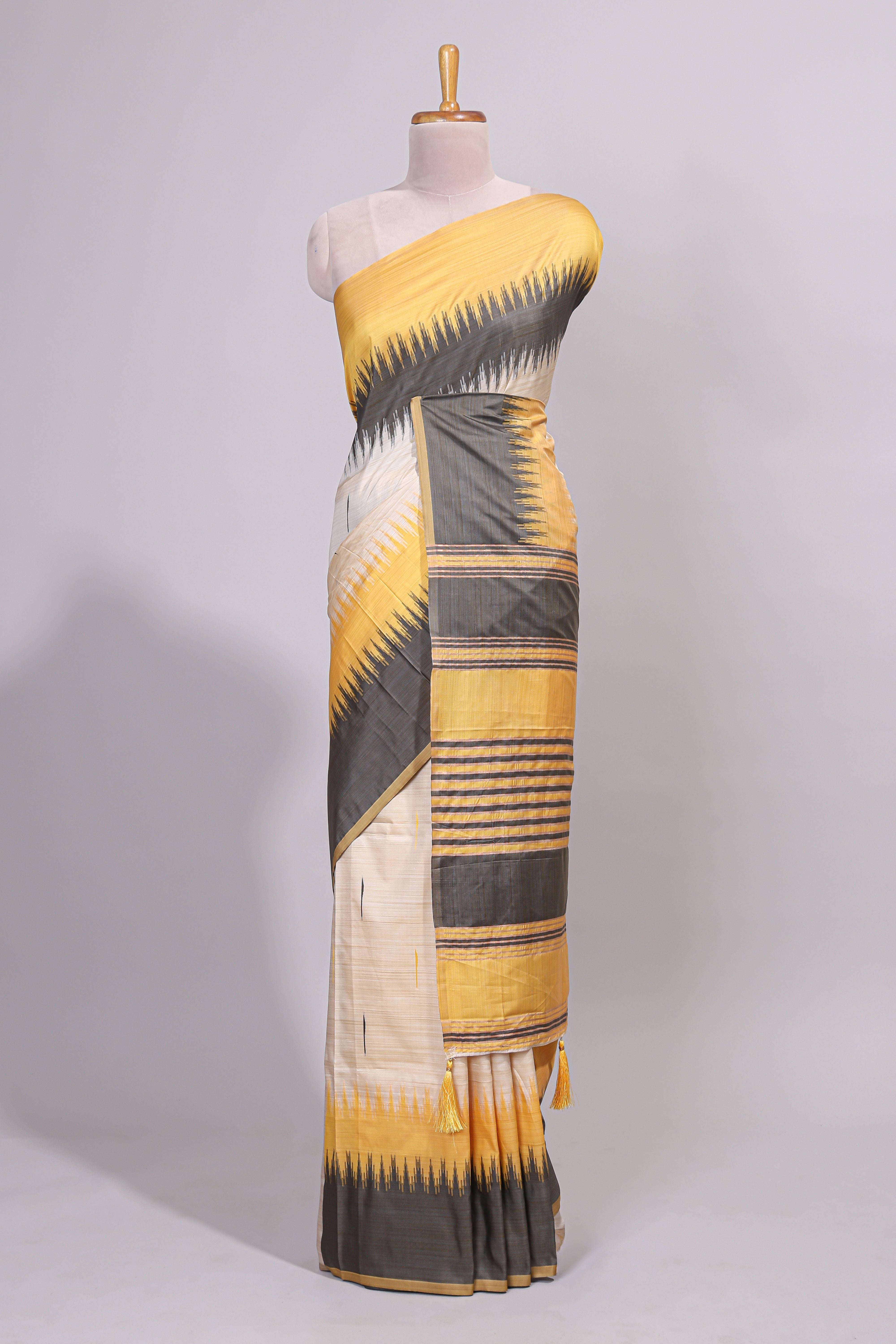 Off white ikkat design semi tussar saree with contrast dual shade border and matching striped blouse