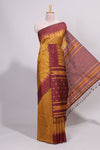 Mustard ikkat motifs design semi tussar saree with contrast border and striped blouse