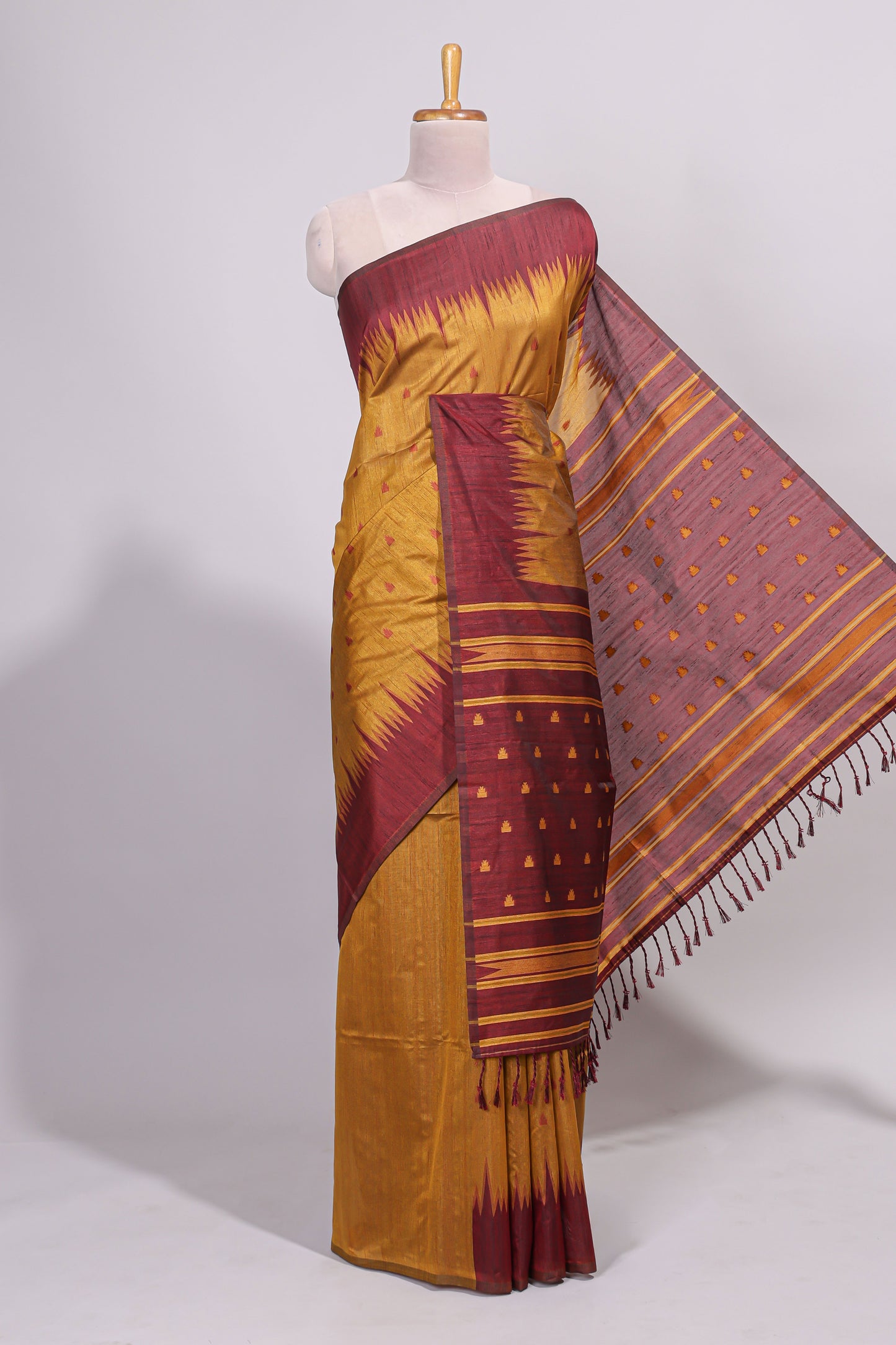 Mustard ikkat motifs design semi tussar saree with contrast border and striped blouse
