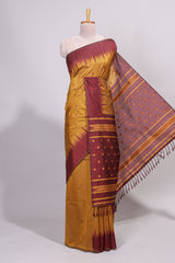 Mustard ikkat motifs design semi tussar saree with contrast border and striped blouse