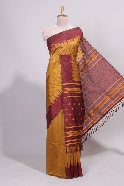 Mustard ikkat motifs design semi tussar saree with contrast border and striped blouse