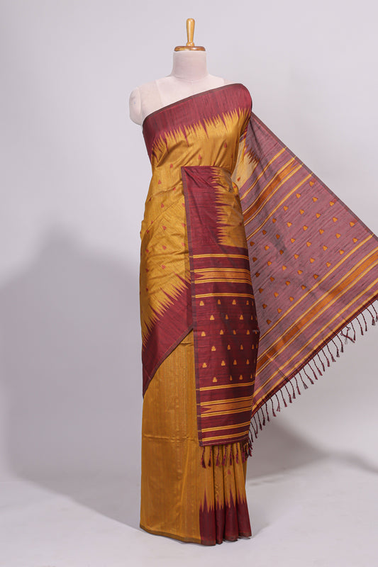 Mustard ikkat motifs design semi tussar saree with contrast border and striped blouse