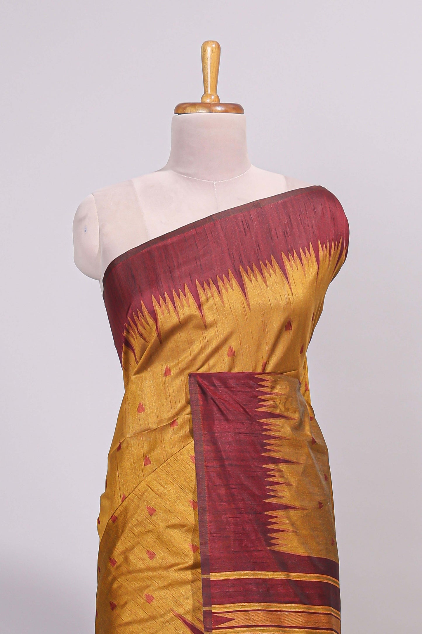 Mustard ikkat motifs design semi tussar saree with contrast border and striped blouse