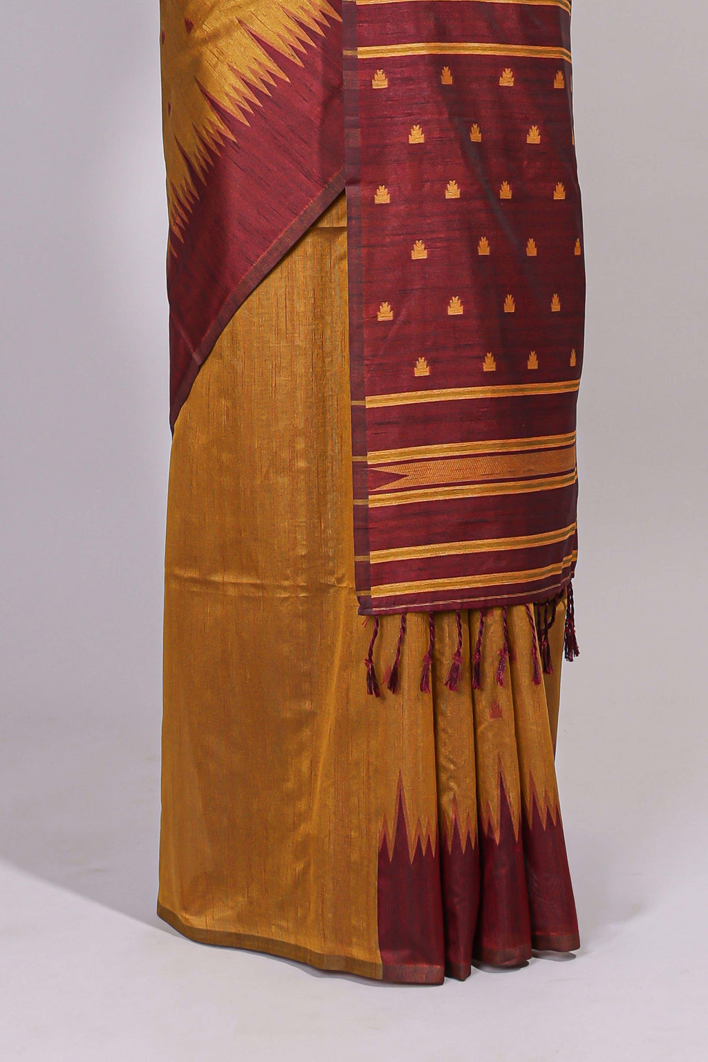 Mustard ikkat motifs design semi tussar saree with contrast border and striped blouse