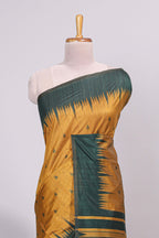 Mustard ikkat motifs design semi tussar saree with contrast green border and striped blouse