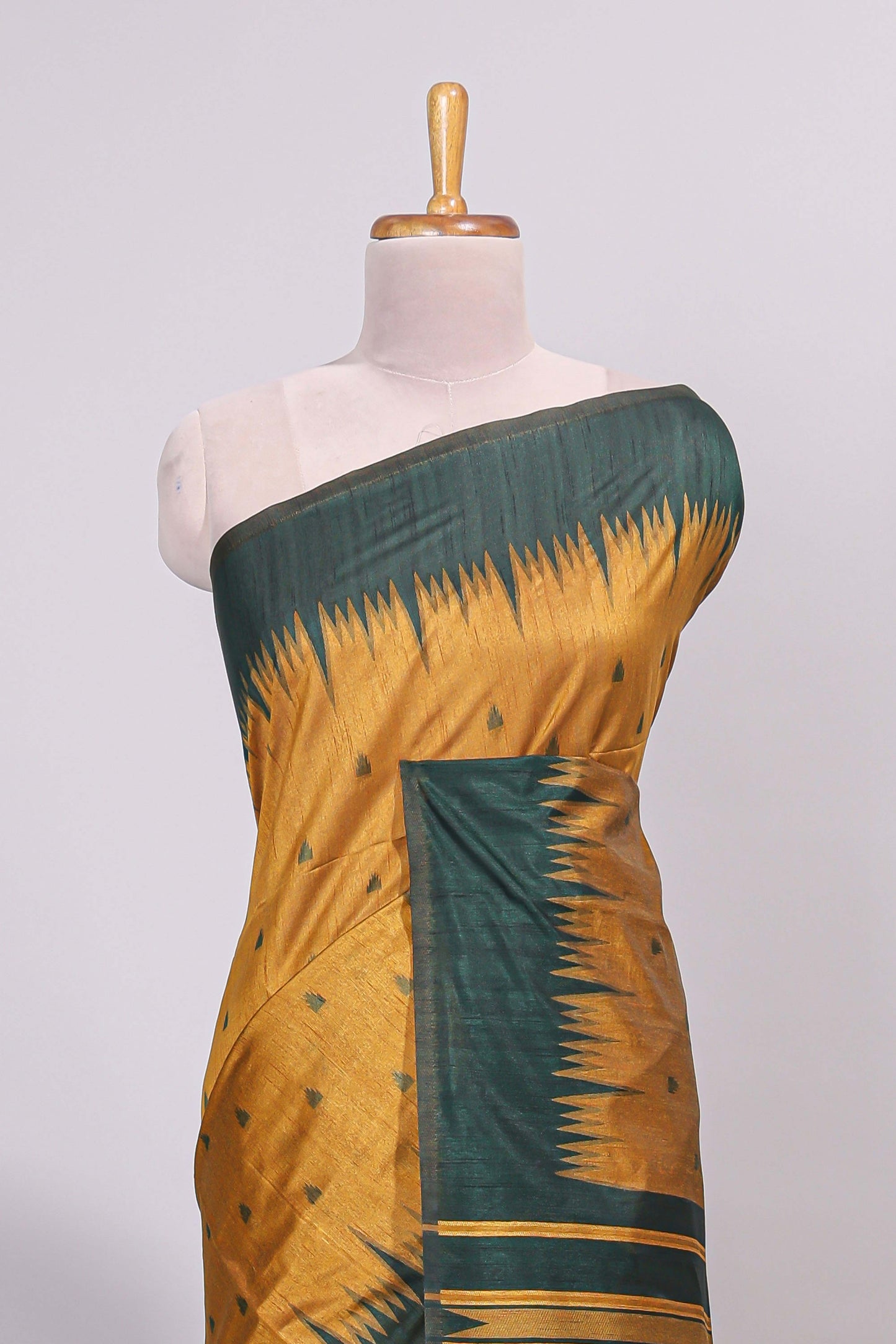 Mustard ikkat motifs design semi tussar saree with contrast green border and striped blouse