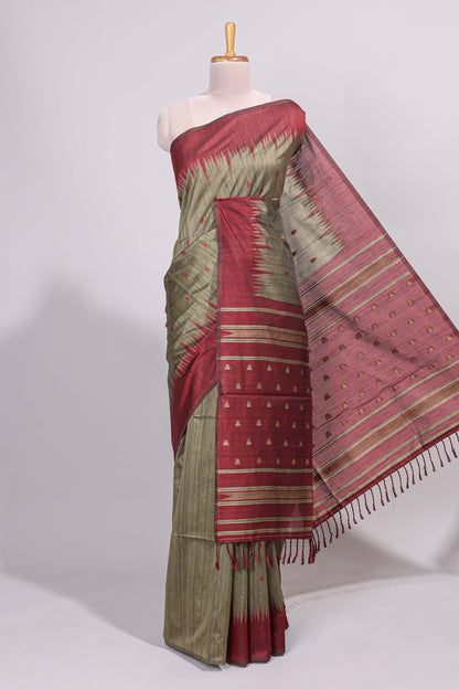 Green ikkat motifs design semi tussar saree with contrast green border and striped blouse