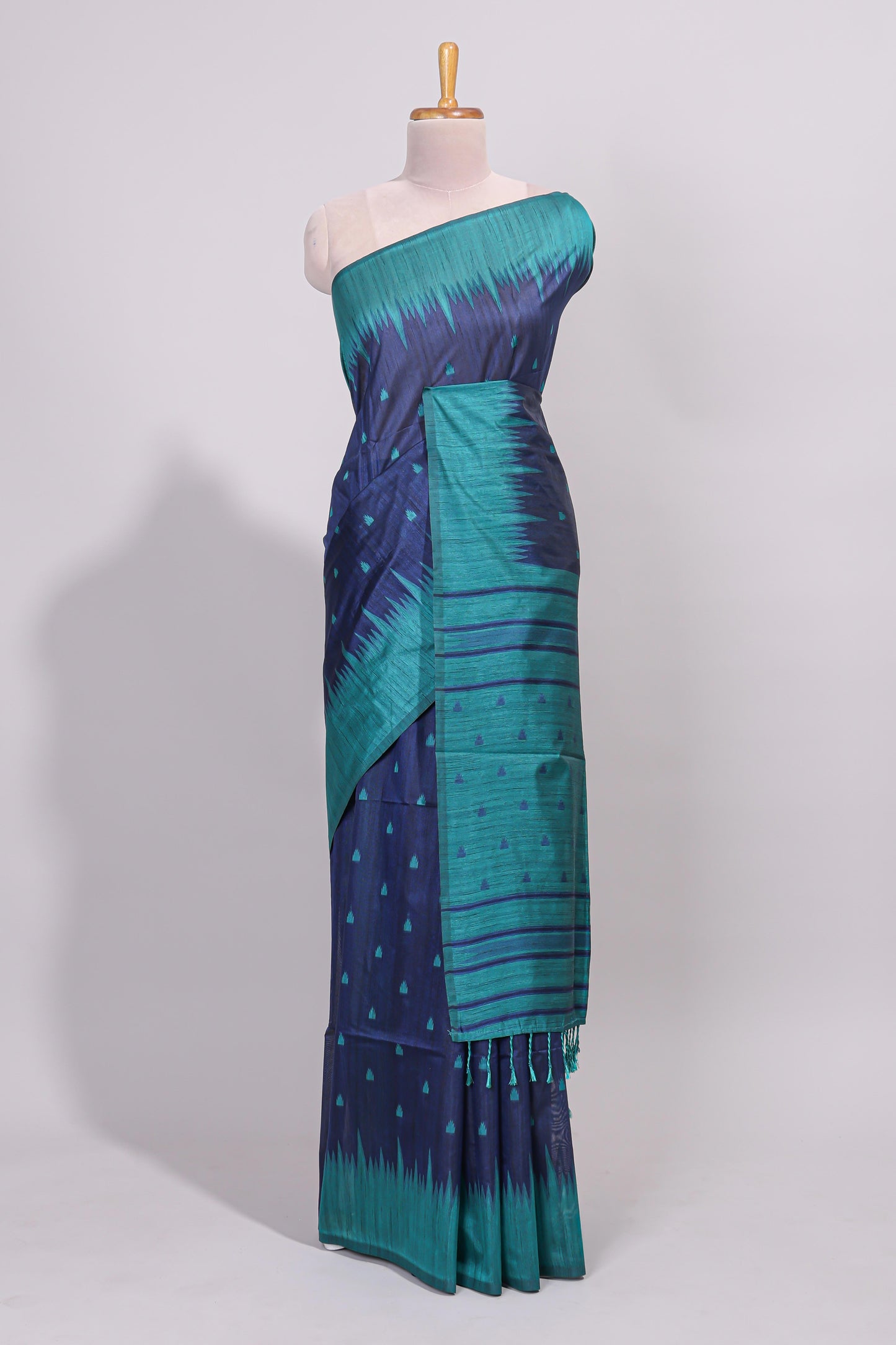 Blue ikkat motifs design semi tussar saree with contrast border and striped blouse