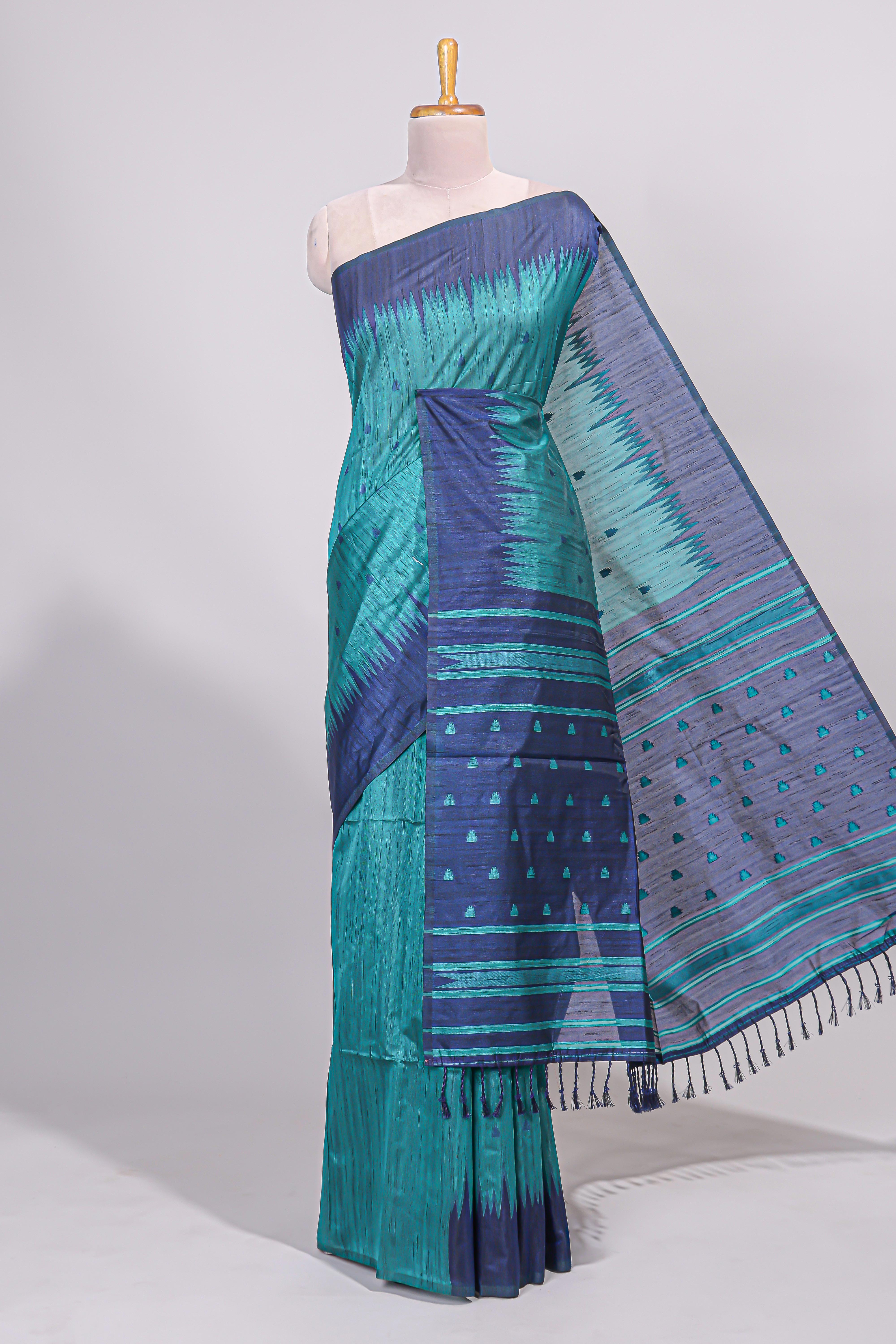 Green ikkat motifs design semi tussar saree with contrast border and striped blouse