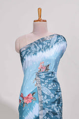 Blue Tussar saree with a floral body featuring bird motifs a printed pallu with tassels and a matchingfloral blouse piece