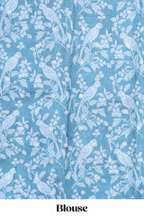 Blue Tussar saree with a floral body featuring bird motifs a printed pallu with tassels and a matchingfloral blouse piece