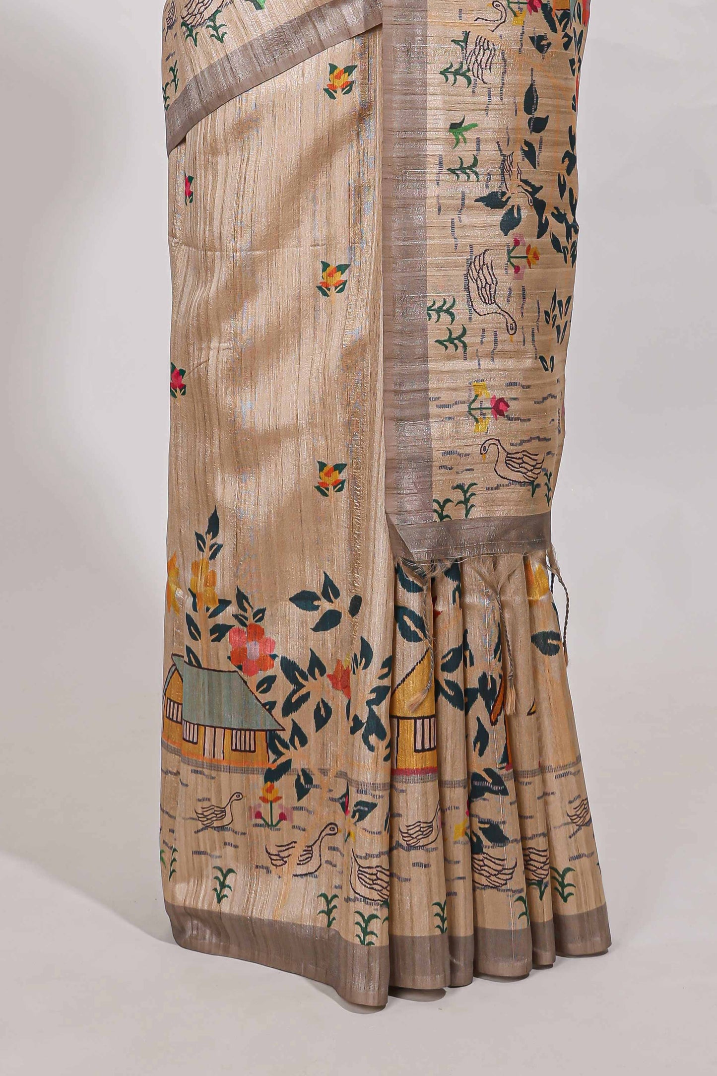 Beige colour artistic village art tussar saree with small border and matching pallu