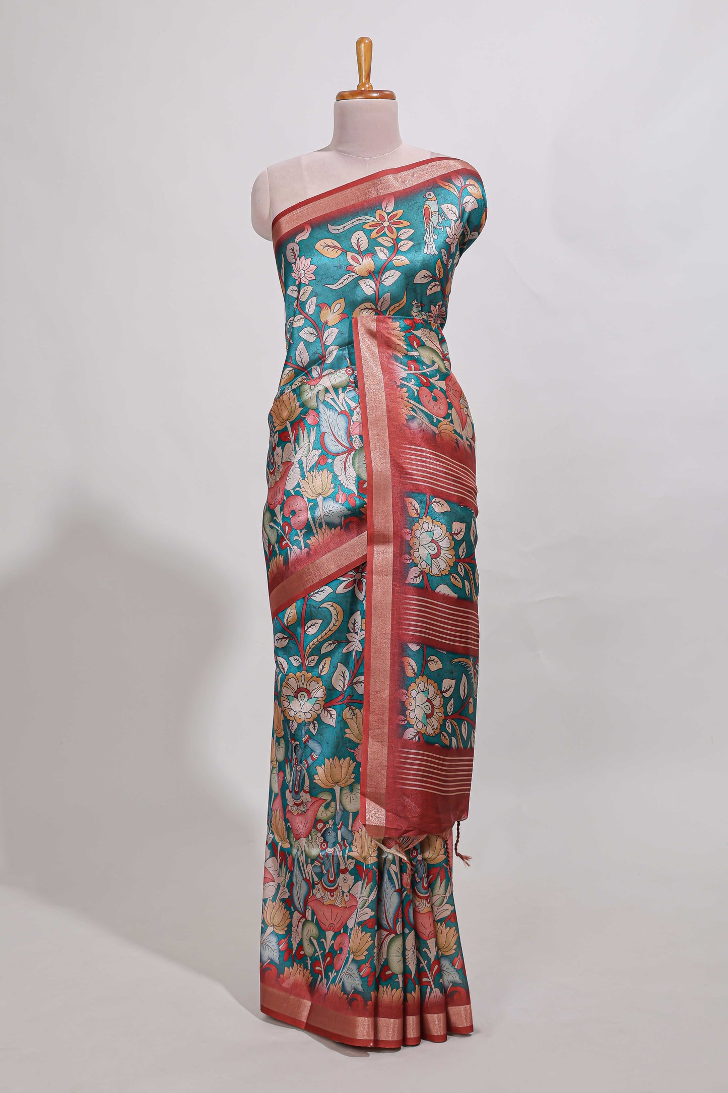 Green kalamkari style tussar saree with small zari border and print pallu with floral print blouse