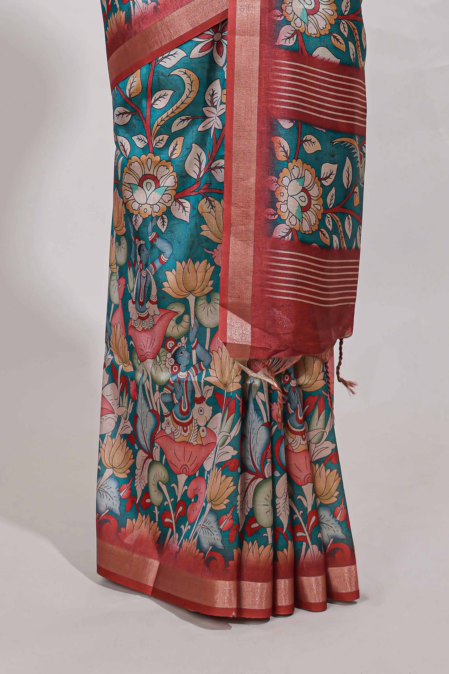 Green kalamkari style tussar saree with small zari border and print pallu with floral print blouse