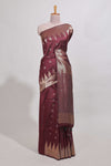 Maroon shimmering zari tussar saree with zari detailing temple pattern borders , and a rich zari pallu