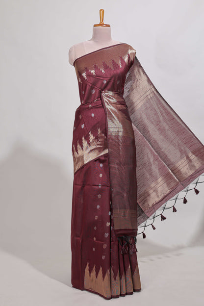 Maroon shimmering zari tussar saree with zari detailing temple pattern borders , and a rich zari pallu