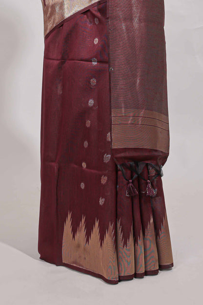 Maroon shimmering zari tussar saree with zari detailing temple pattern borders , and a rich zari pallu