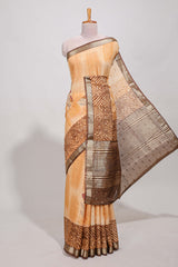 Orange geomatric tussar saree contrasting brown border with geomatric patterns ,and matching pallu with zari stripes blouse