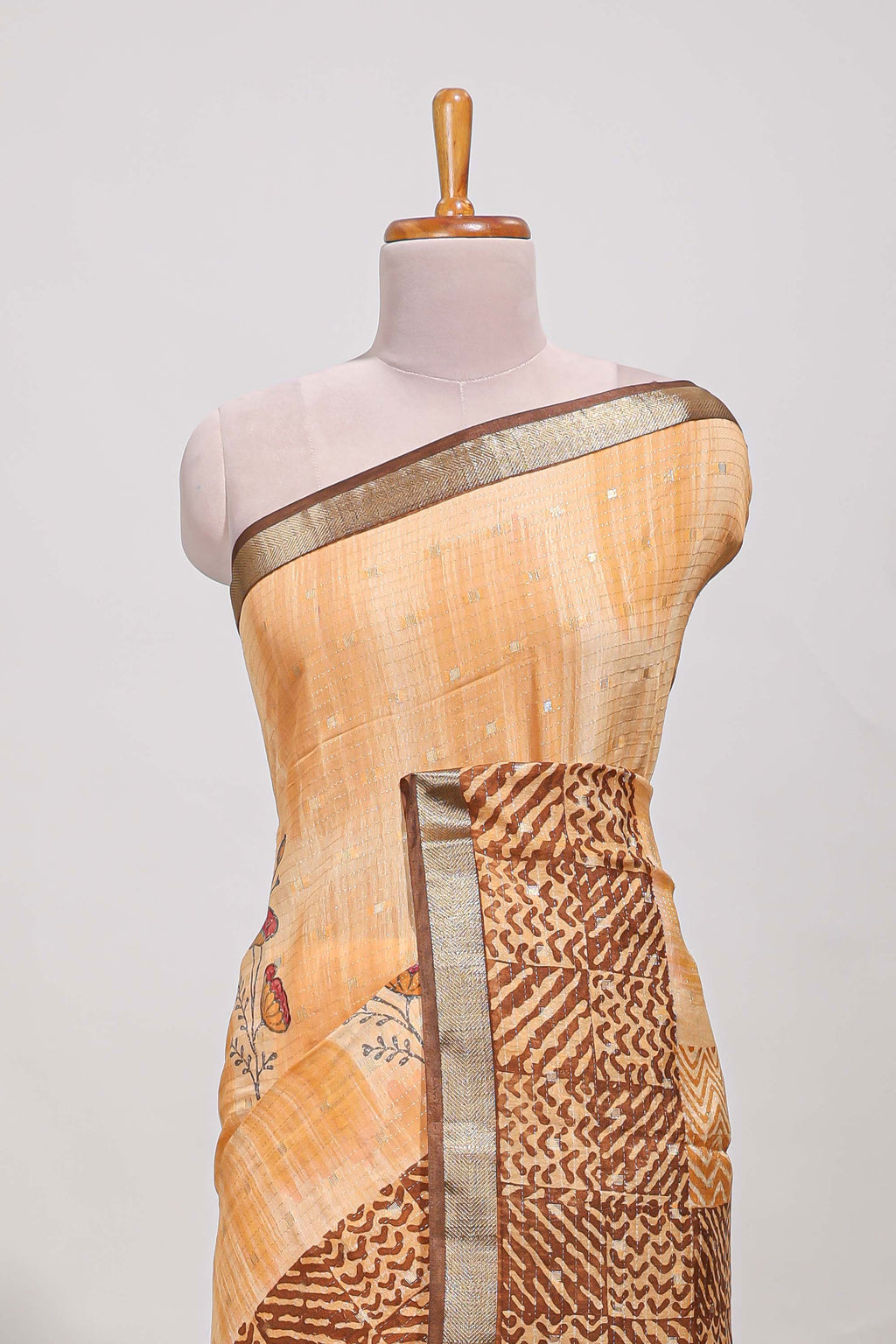 Orange geomatric tussar saree contrasting brown border with geomatric patterns ,and matching pallu with zari stripes blouse
