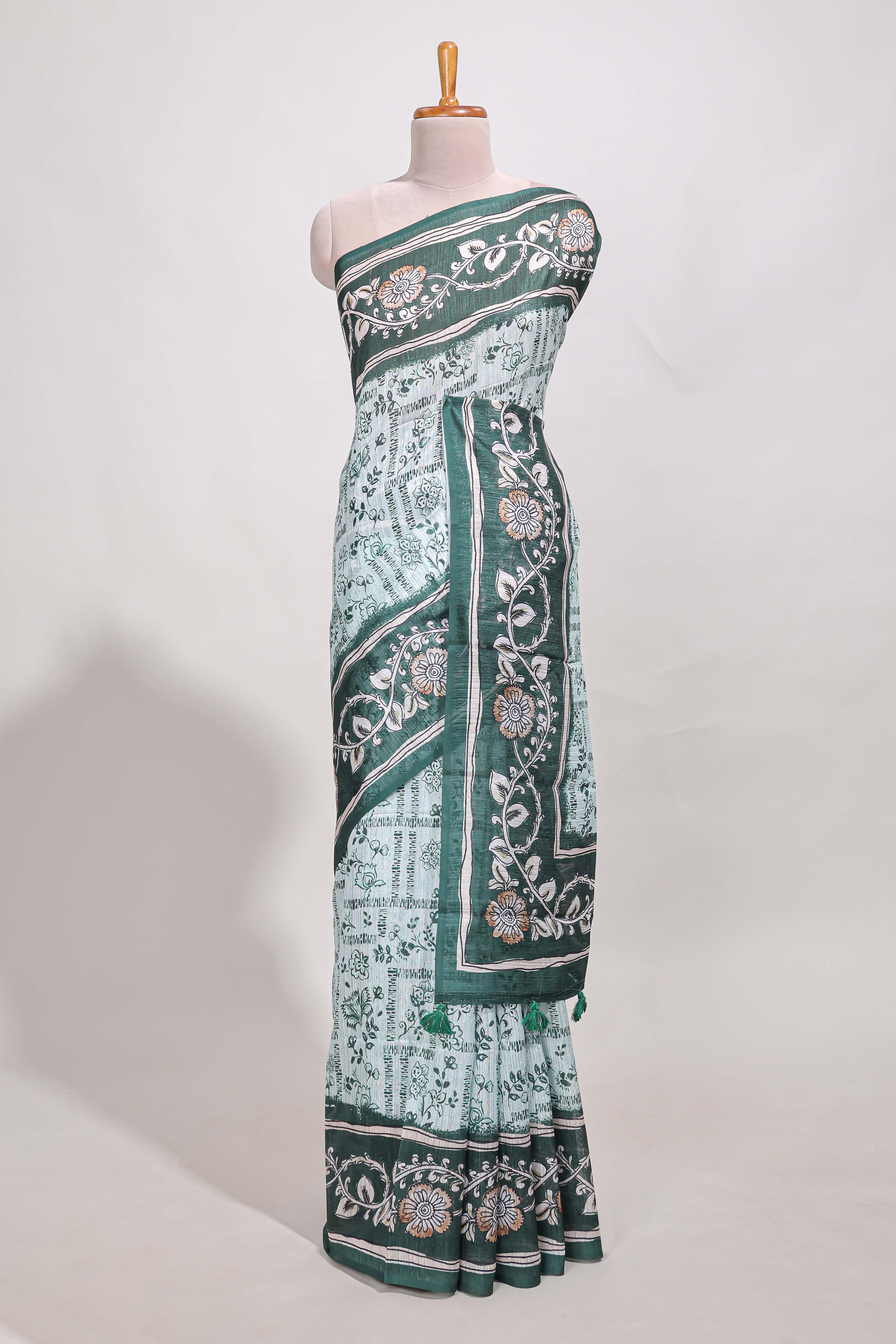 Green colour floral printedsemi tussar saree with creeperborder and matching printed blouse