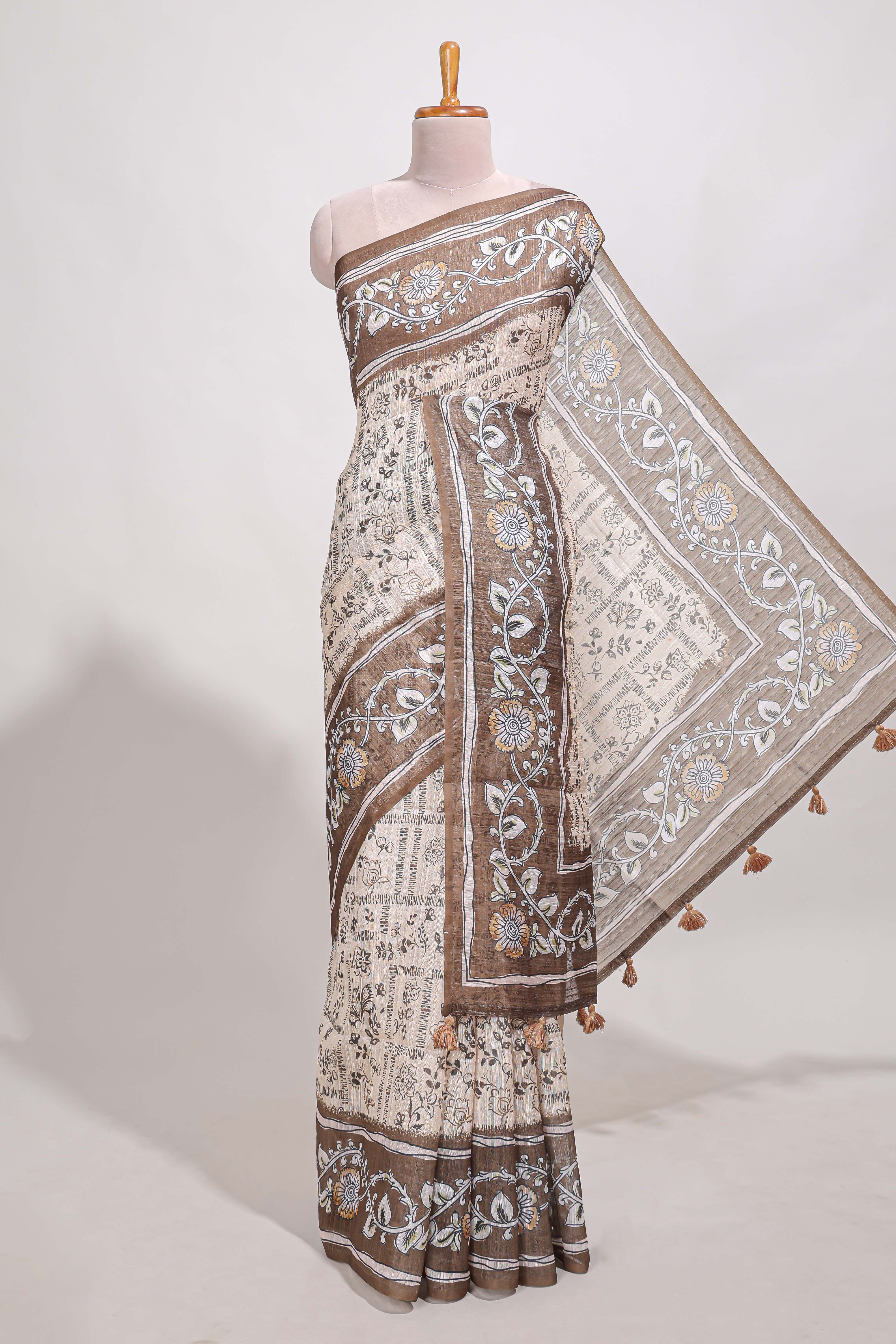 Brown colour floral printedsemi tussar saree with creeperborder and matching printed blouse