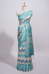 Teal blue tussar saree body chevron prints floral motifs and printed pallu along with matching blouse