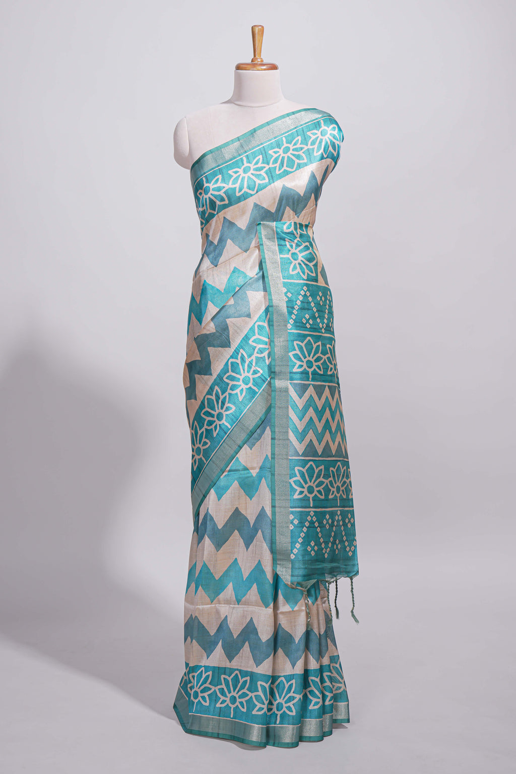 Teal blue tussar saree body chevron prints floral motifs and printed pallu along with matching blouse