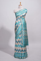 Teal blue tussar saree body chevron prints floral motifs and printed pallu along with matching blouse