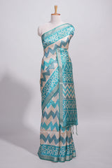 Teal blue tussar saree body chevron prints floral motifs and printed pallu along with matching blouse