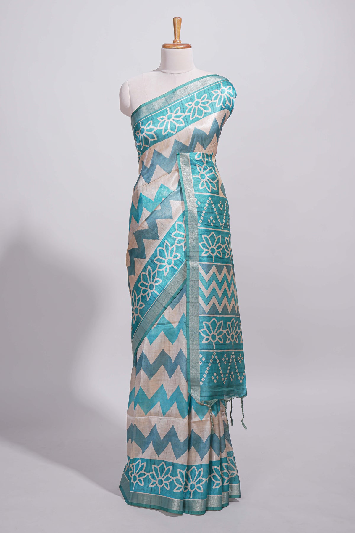 Teal blue tussar saree body chevron prints floral motifs and printed pallu along with matching blouse