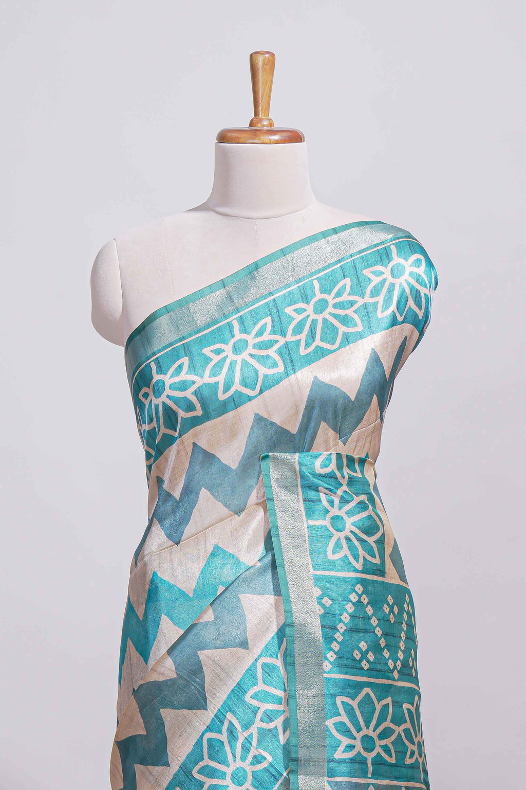 Teal blue tussar saree body chevron prints floral motifs and printed pallu along with matching blouse