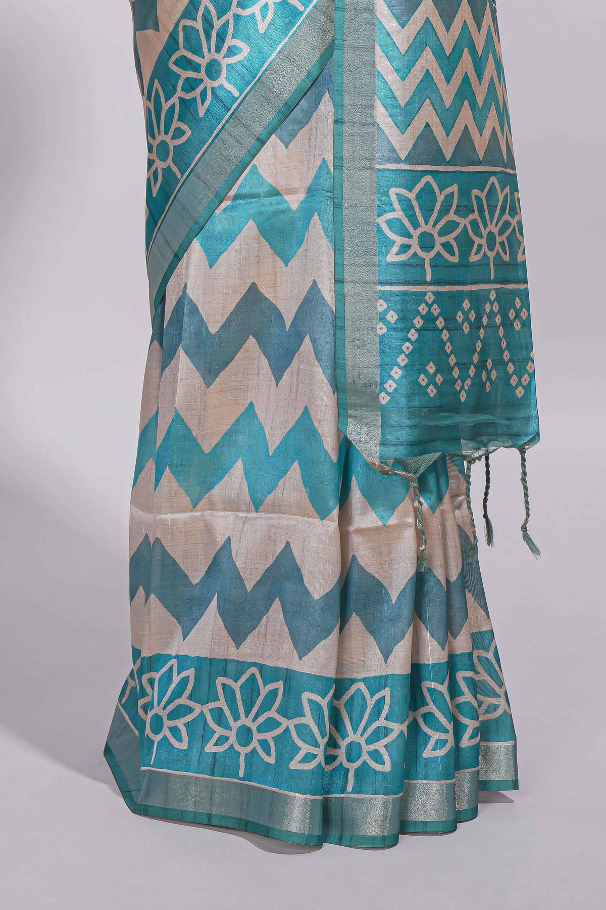 Teal blue tussar saree body chevron prints floral motifs and printed pallu along with matching blouse